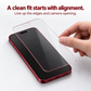 A single thin glass screen protector held above a phone for alignment with its screen edges and camera opening.
